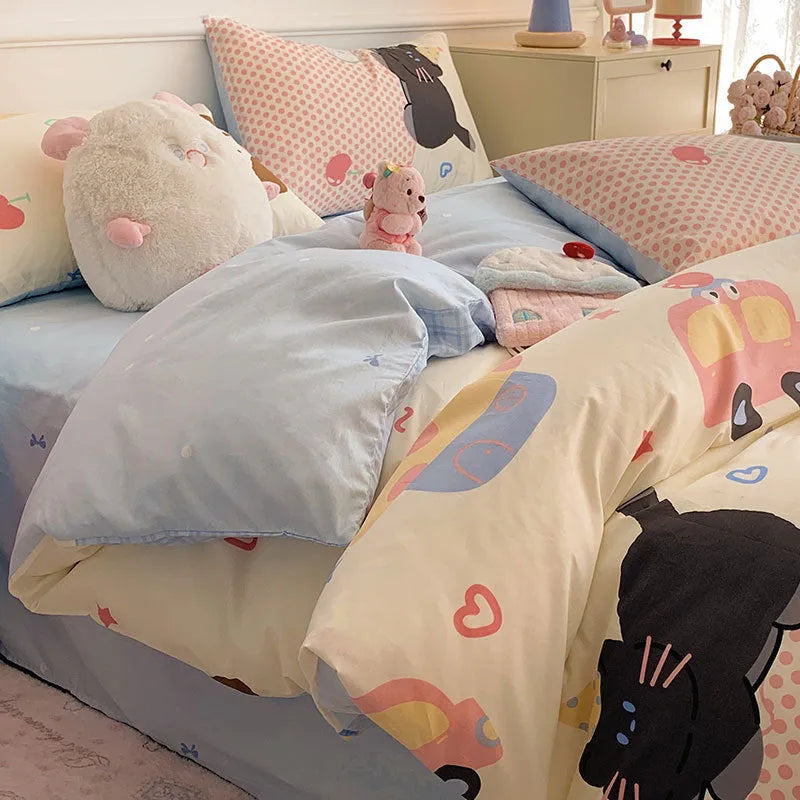 Cartoon dog pattern four-piece pure cotton bedding set laid on a dormitory bed.