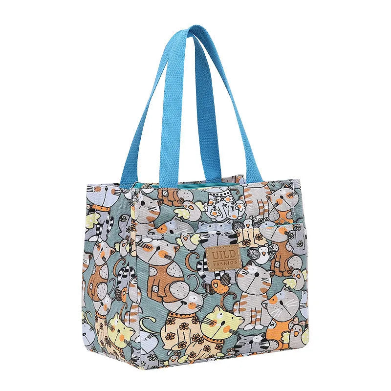 Women's square canvas handbag with floral and animal prints, showing aluminium hardware.
