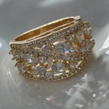 Women's round hollow copper fashion ring with a choice of gemstone colours, shown in gold and platinum finishes.