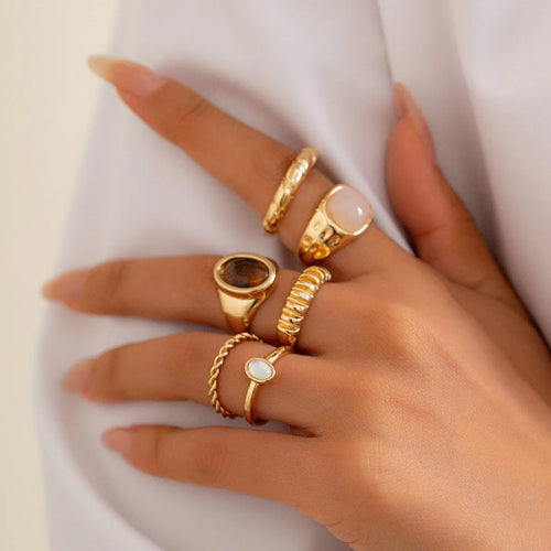 Six light gold geometric alloy rings with electroplated finish displayed together