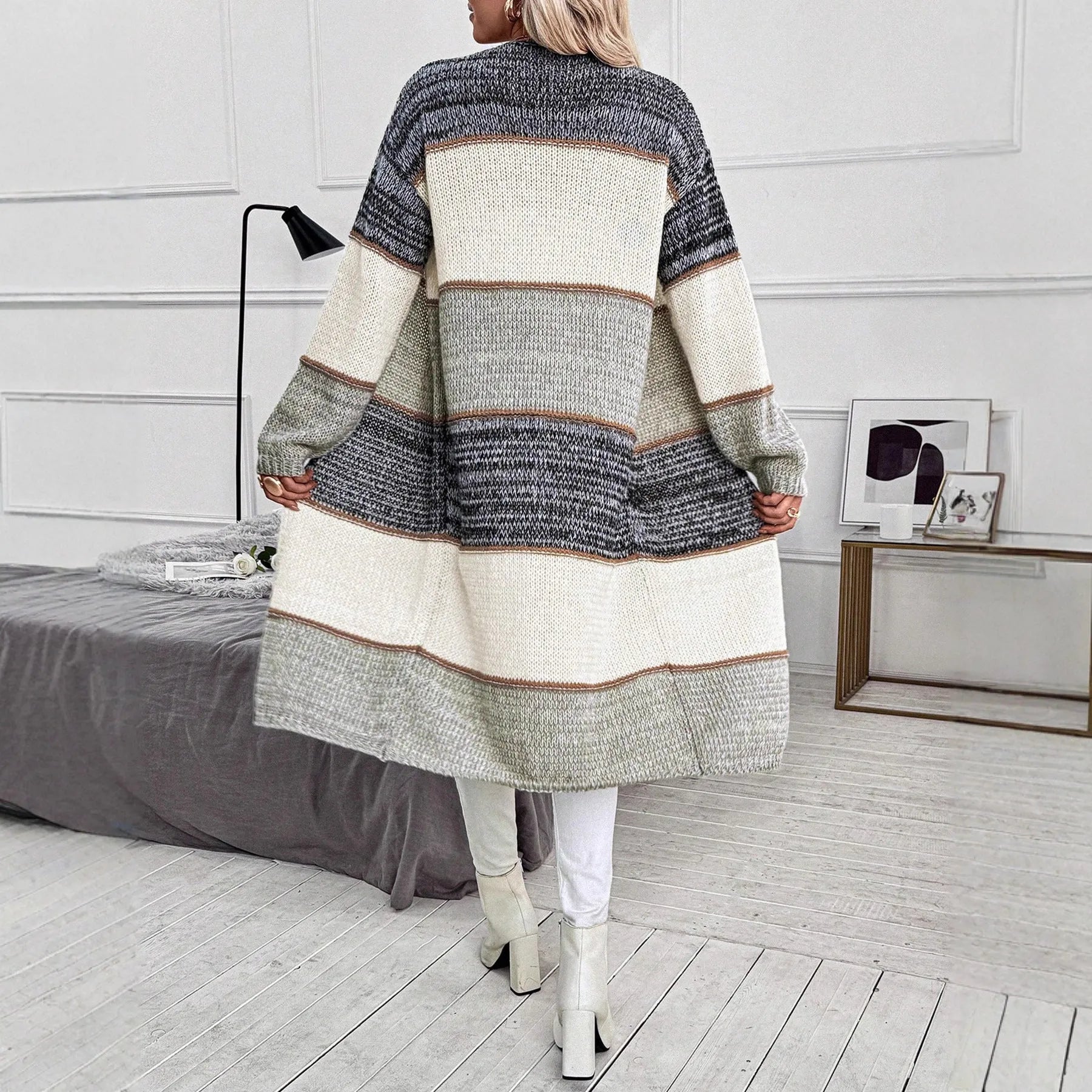 Grey women's long knitted cardigan with loose fit and long sleeves, shown in stripe or plaid pattern.