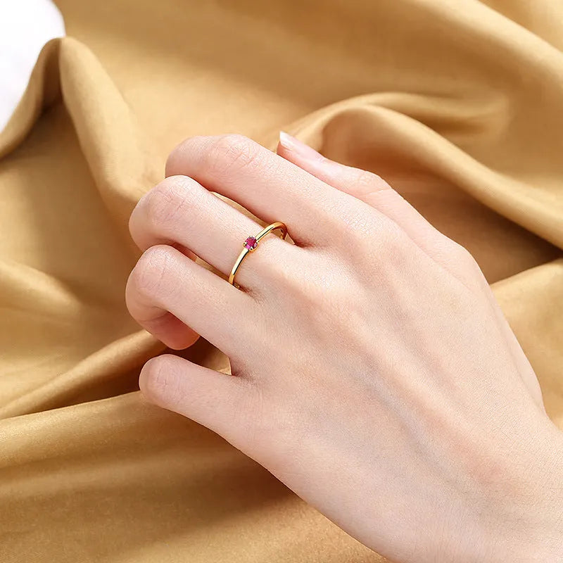 A personalised simple single diamond fine circle ring for women, made from copper, shown in a geometric round design.