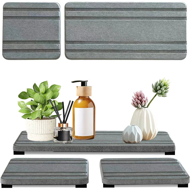 Three square diatom oil water draining pads in solid colours on a bathroom countertop.