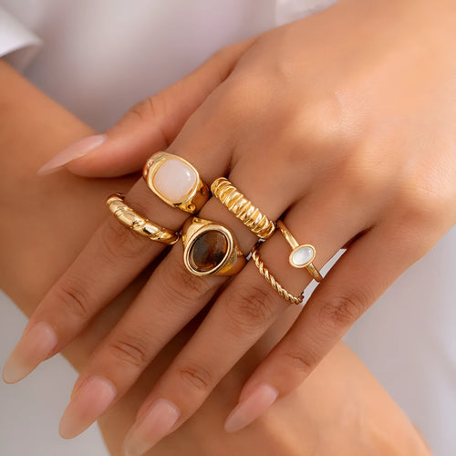 Six light gold geometric alloy rings with electroplated finish displayed together