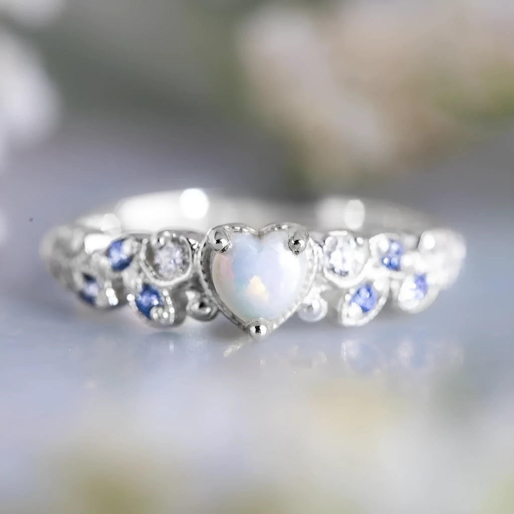 Women's peach-coloured heart ring with floral and opal design, silver-white electroplated finish.