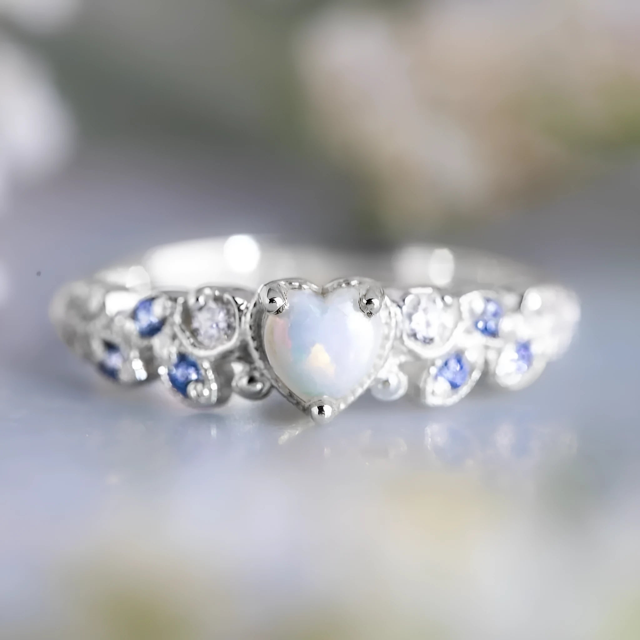 Women's peach-coloured heart ring with floral and opal design, silver-white electroplated finish.