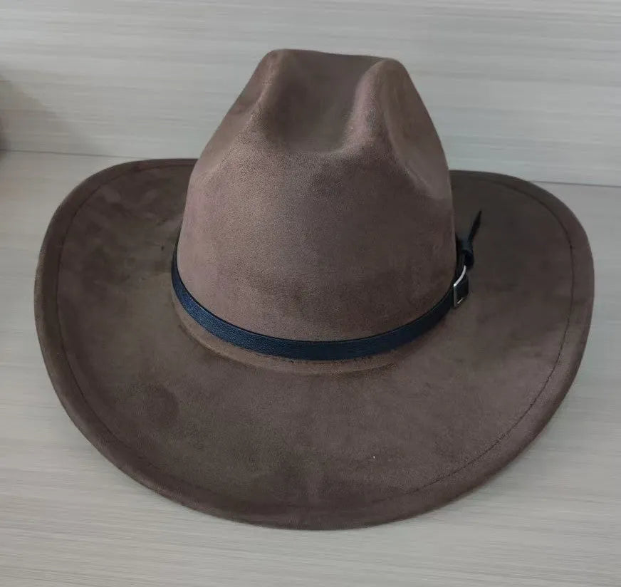 Brown leather velvet curved edge Western cowboy hat with a conical crown on a wooden surface.