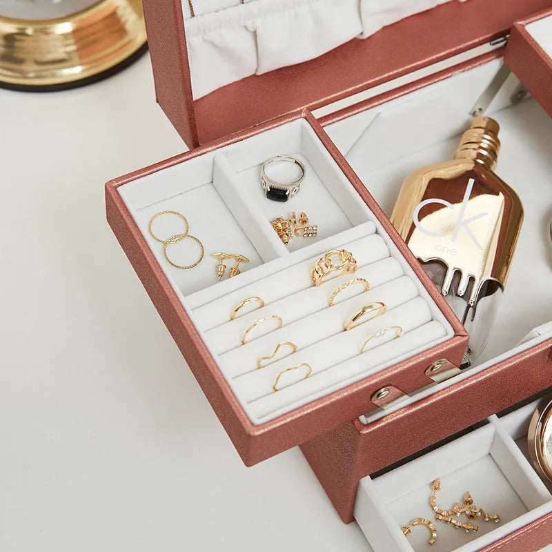 Hard black PU leather jewellery storage box with organised compartments for rings and necklaces.