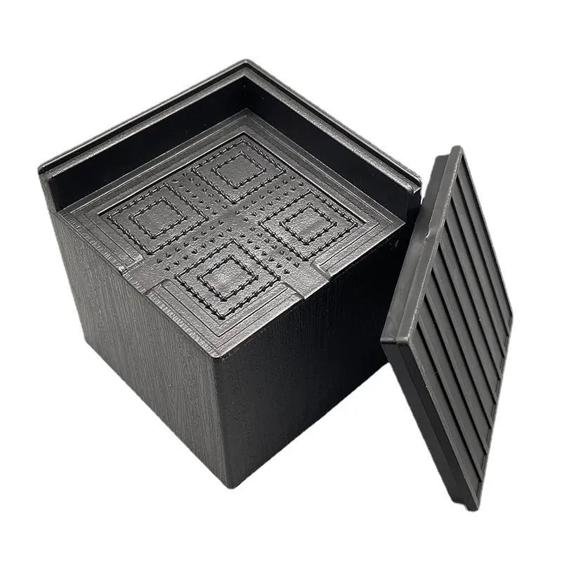 Four black plastic furniture foot mats for bed and sofa height adjustment