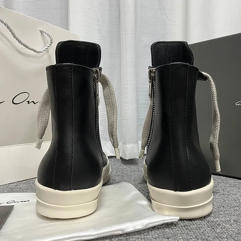 Black high-top leather shoes with a side zip and round toe on a rubber sole.