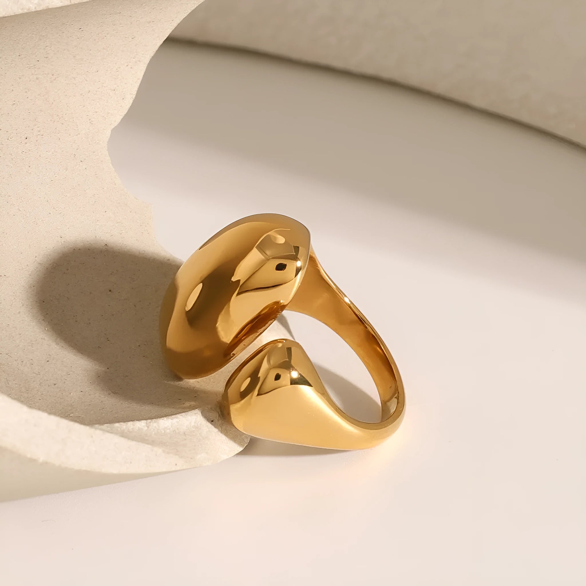 Women's exaggerated geometric open ring in stainless steel with electroplated finish.
