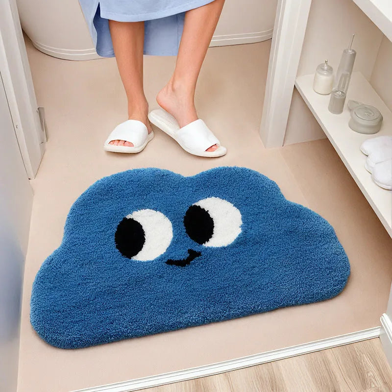 Big Eye Clouds cartoon anime bathroom mat in soft green, shown on a tiled bathroom floor.