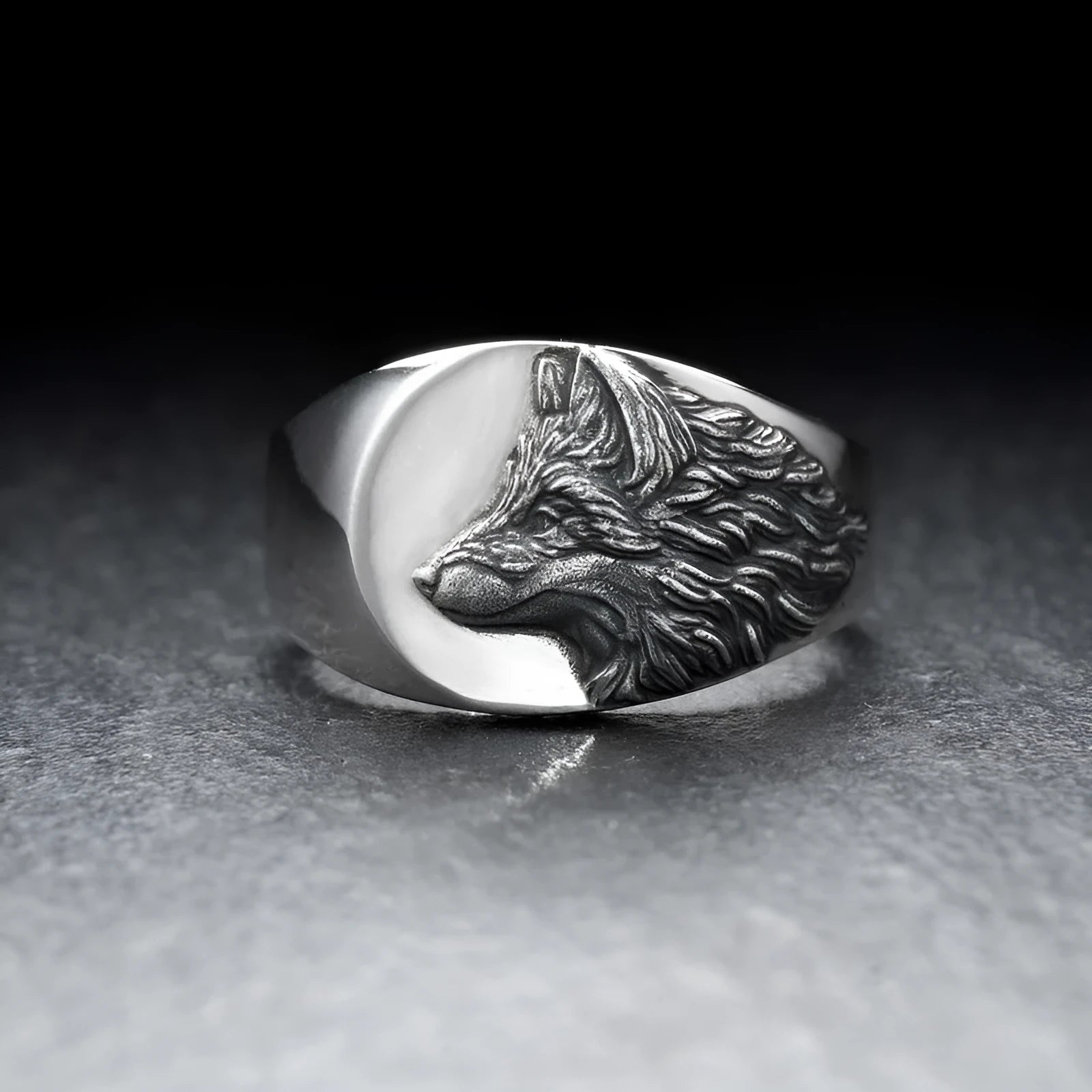 Geometric silver wolf head men's ring made of alloy metal on a grey background.