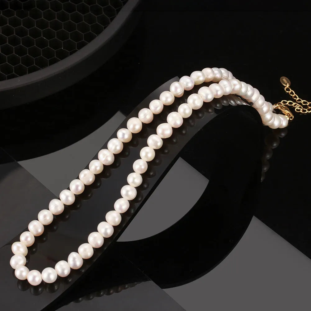 Women's adjustable silver necklace with natural freshwater pearls on a model