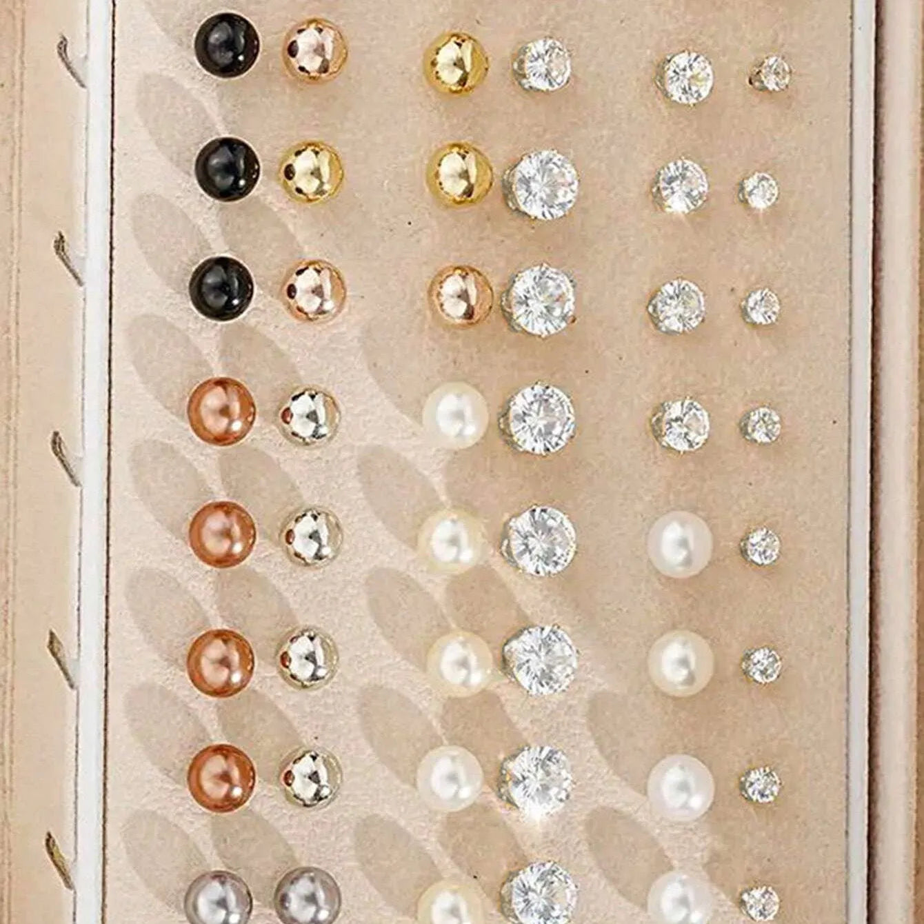 108 gold and yellow geometric and round alloy drop earrings laid out.