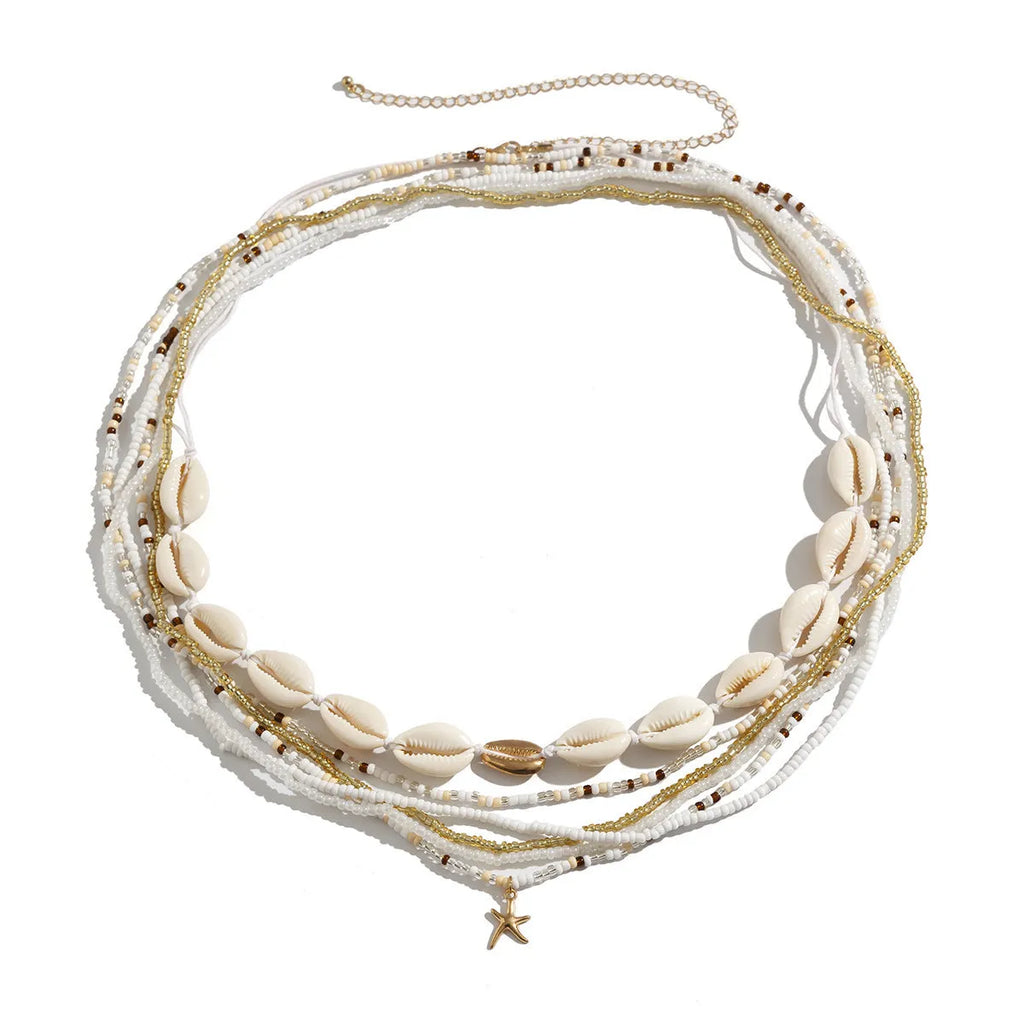 Close-up of a gold-toned alloy waist chain with woven shell beads, shown in a multi-circle Bohemian style.