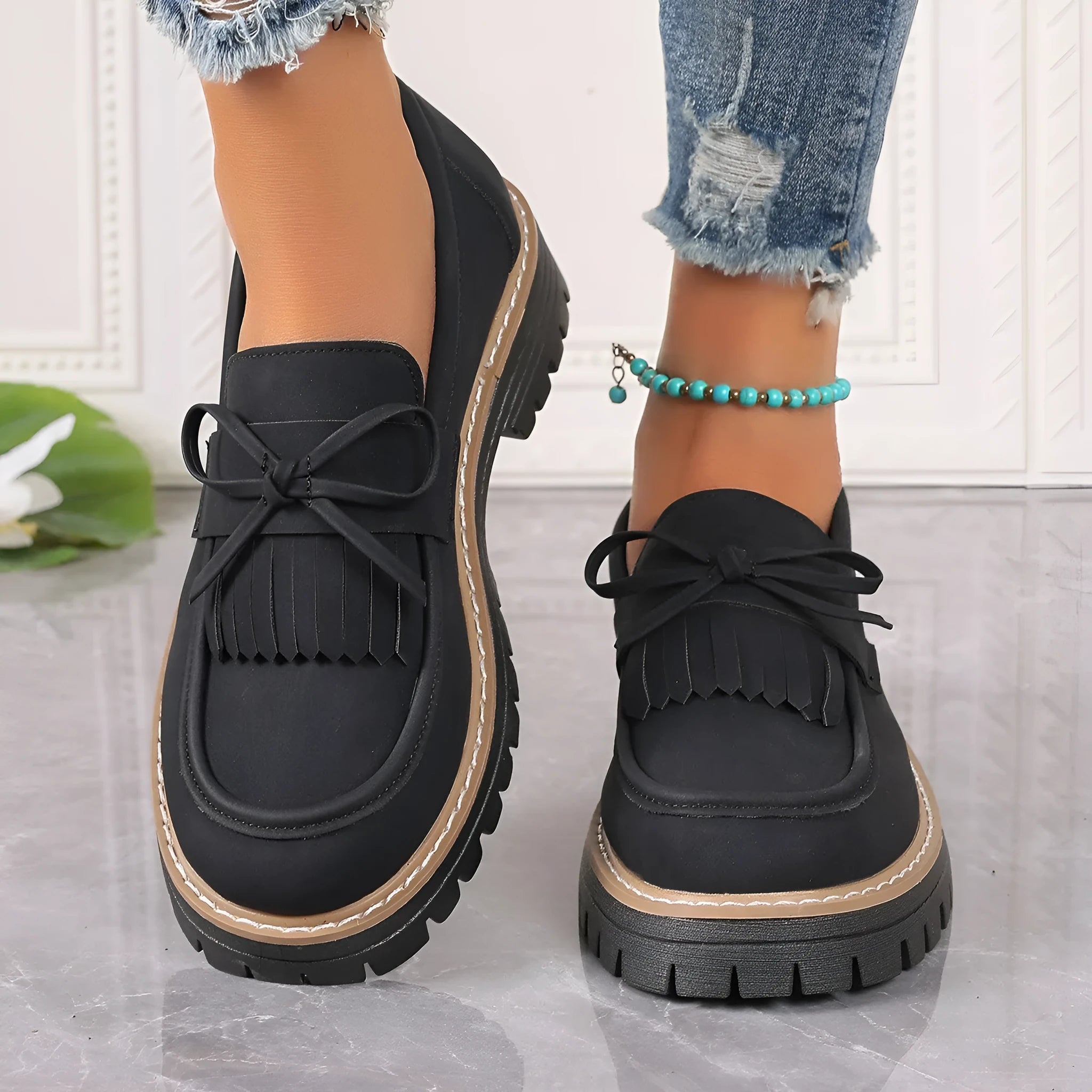Black plus size women's loafers with a tassel and bowknot on a low-top PU upper.
