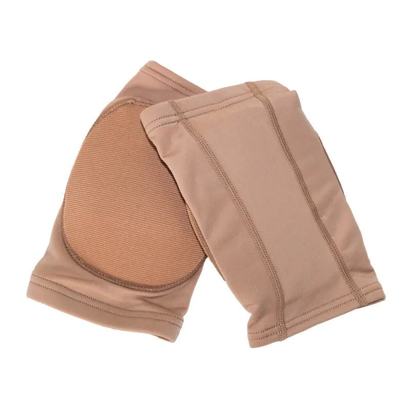 A pair of black knee pads for ballet dance and yoga exercise on a grey background.