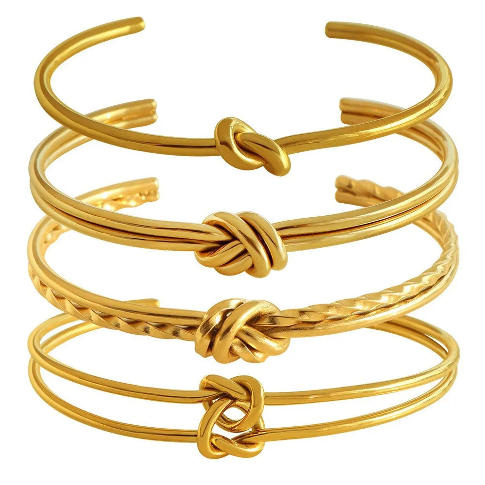 Adjustable stainless steel women's bracelet with gold plating and a double-layer knotted C-shape design.