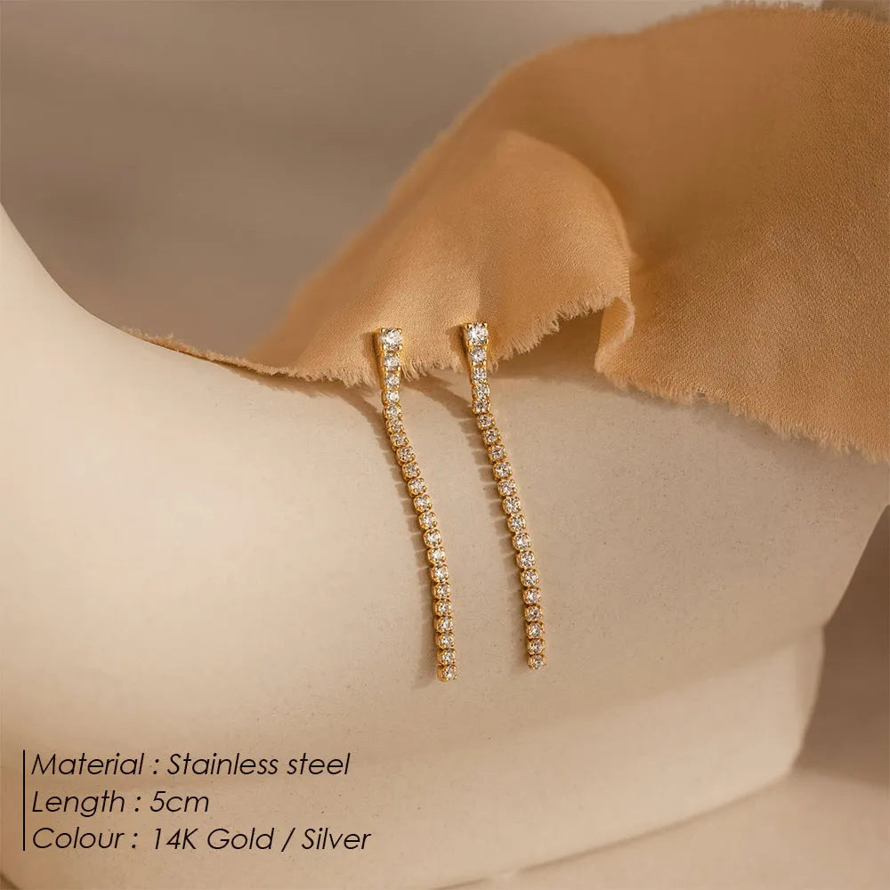 Geometric line pattern stainless steel stud earrings with zircon stones in gold colour.