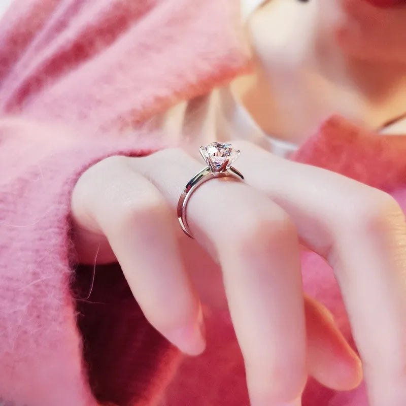 White gold plated geometric ring with a six-claw setting holding a zircon stone