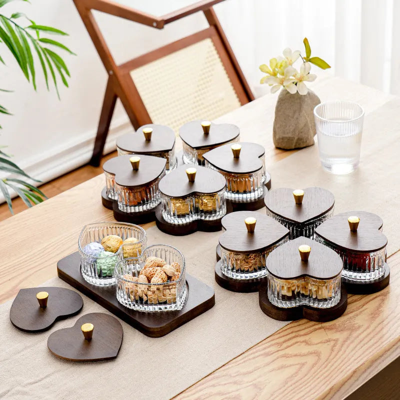Glass serving platter with heart-shaped transparent lids in a 4-grid configuration on a table.