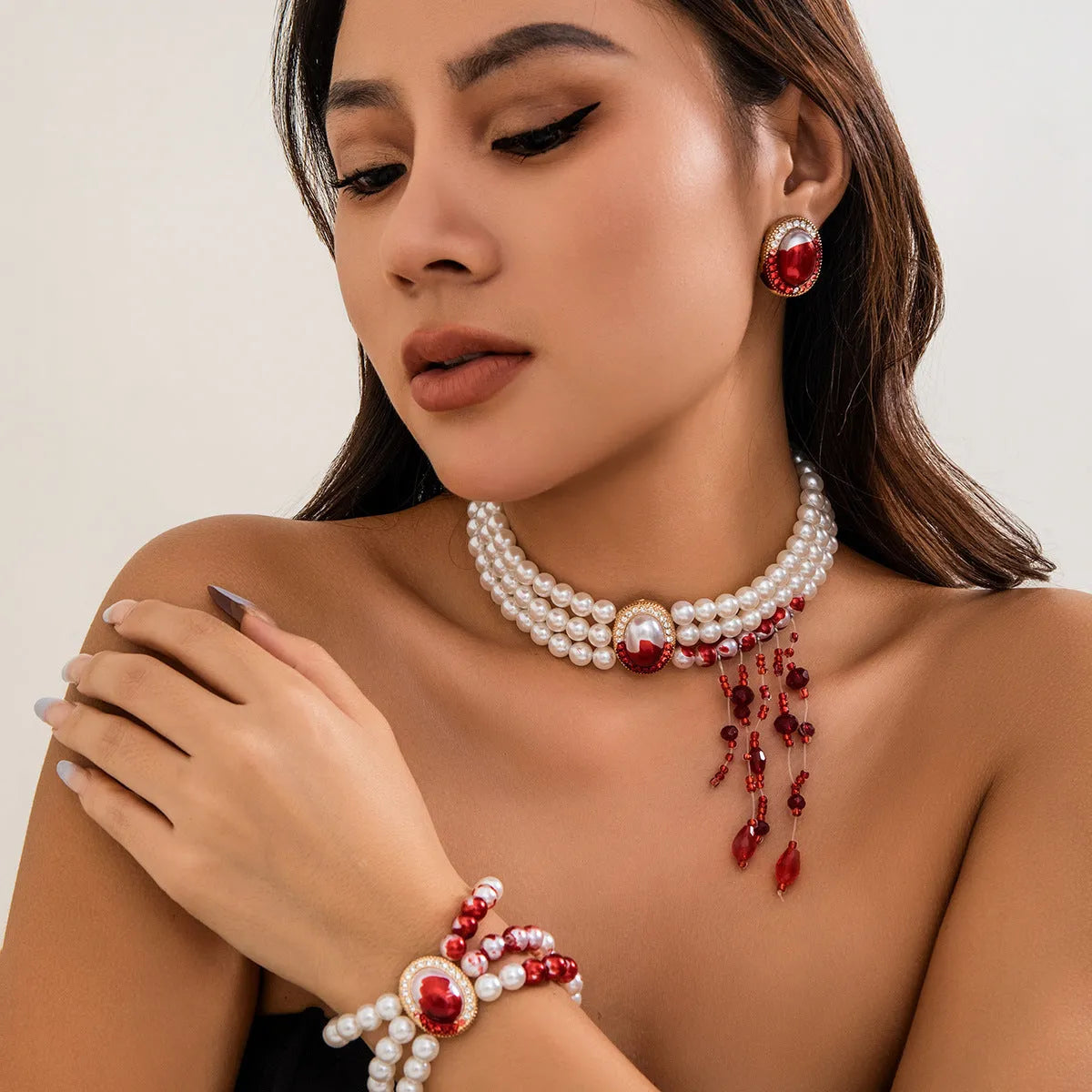 Gold Halloween pearl collar jewellery set with necklace, bracelet, and stud earrings on white background
