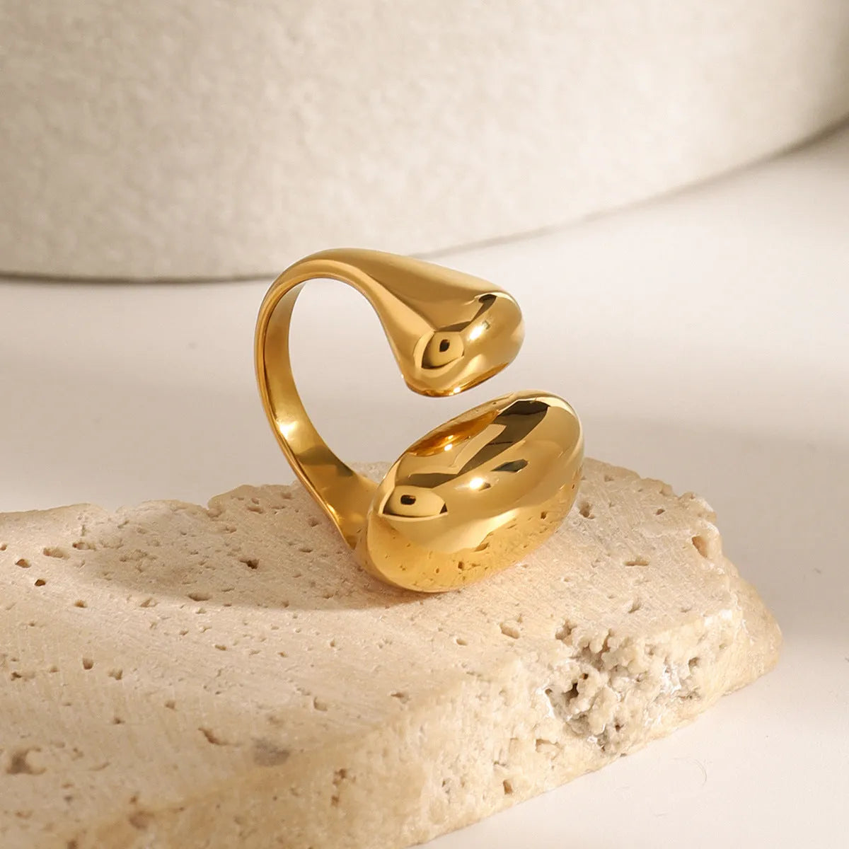 Women's exaggerated geometric open ring in stainless steel with electroplated finish.