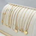 Set of ten gold-coloured women's necklaces with snake bones chains and alloy pendants.