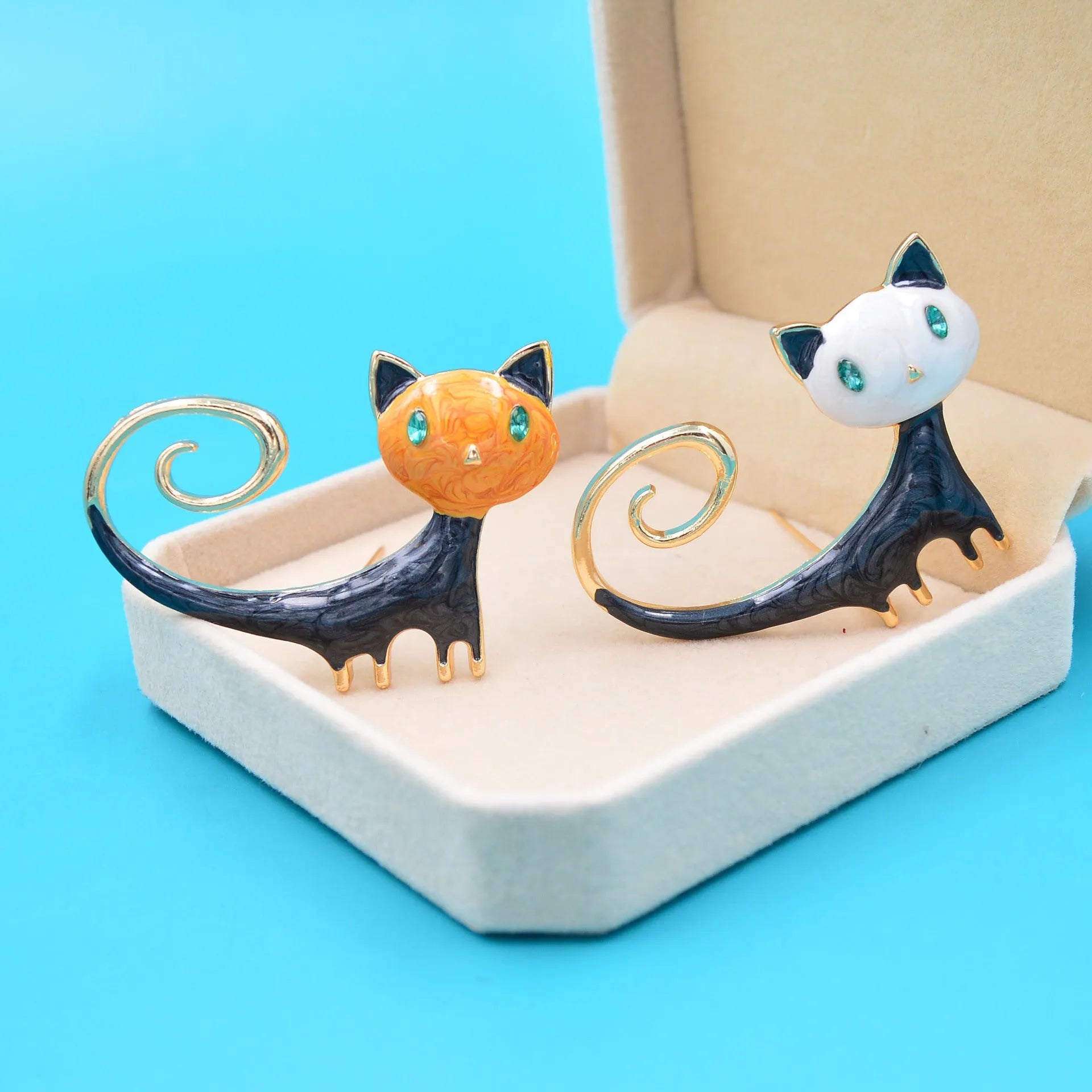 Personalised painted alloy brooch showing a cat design with raised tail, in orange and white colour options