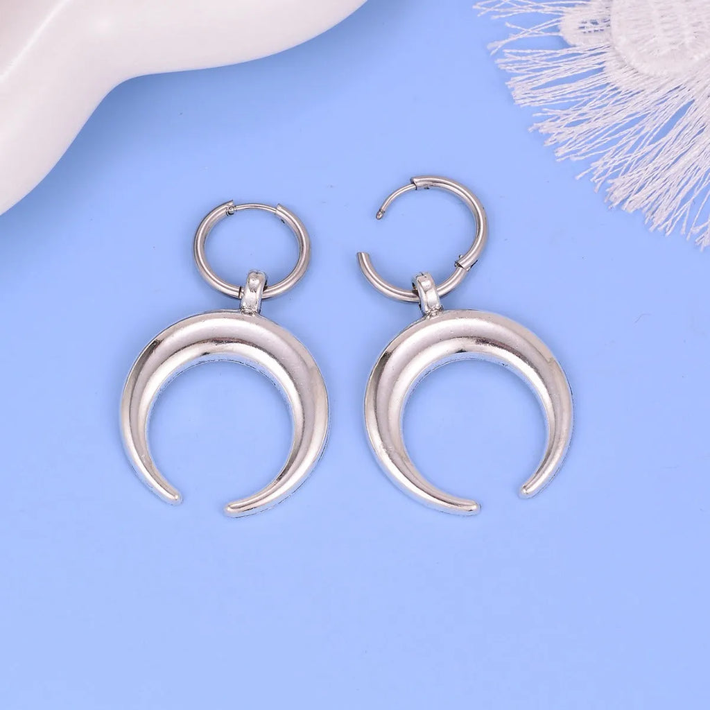 Silver big hoop earrings with a geometric shape and gothic moon design.