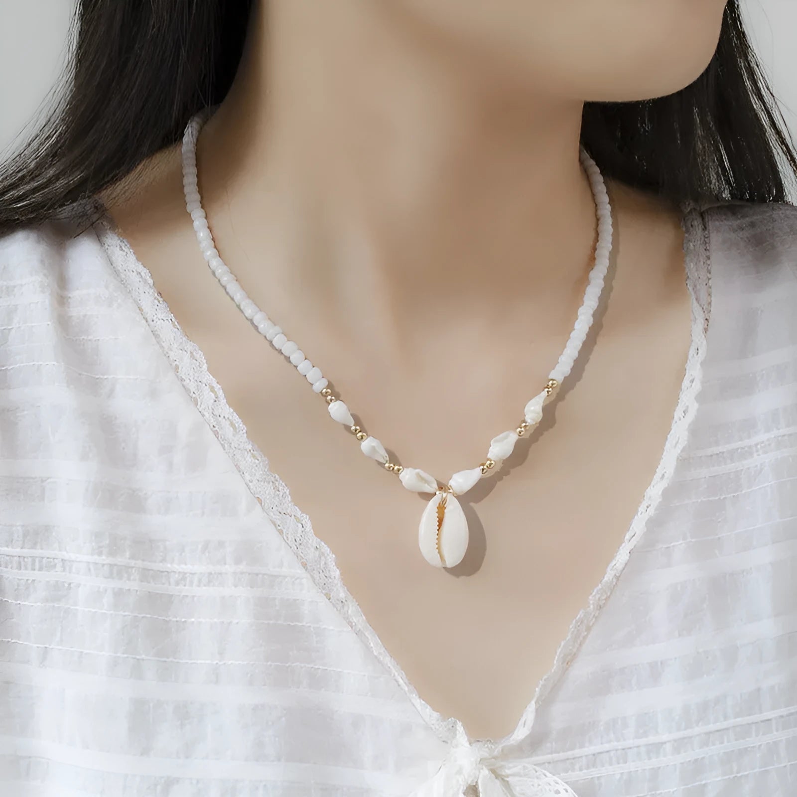White conch shell bead necklace with a mother-of-pearl pendant on a regular chain.