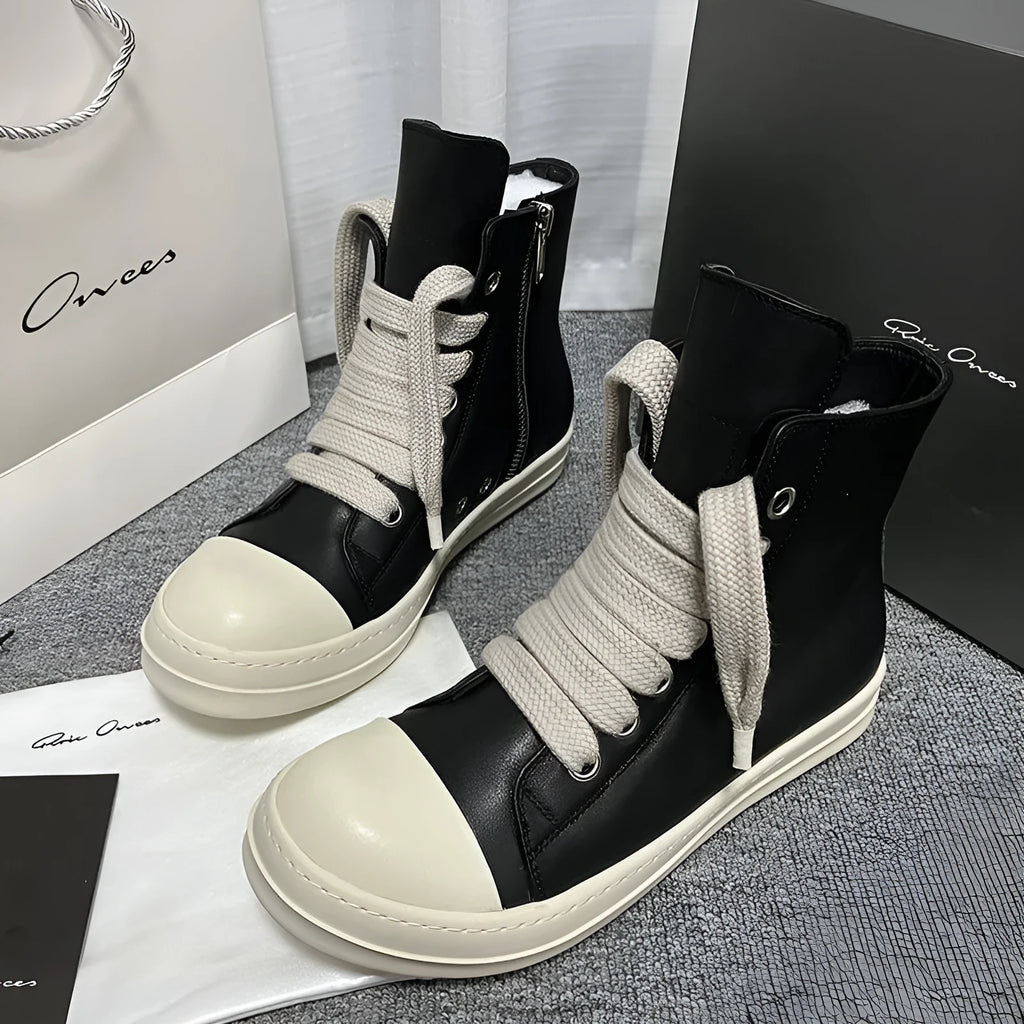 Black high-top leather shoes with a side zip and round toe on a rubber sole.