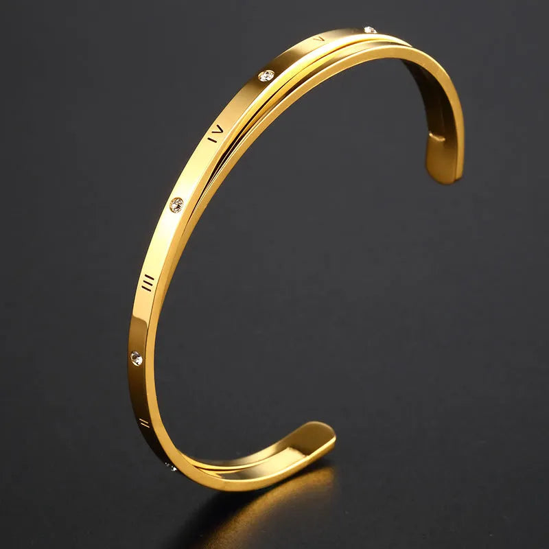 Open-ended stainless steel women's bracelet with zircon stones in rose gold colour.