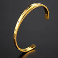 Open-ended stainless steel women's bracelet with zircon stones in rose gold colour.
