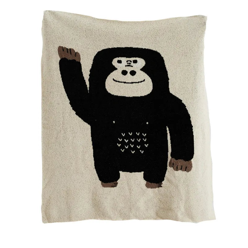 Cartoon anime knitted velvet pillowcase in black big face design on a bed