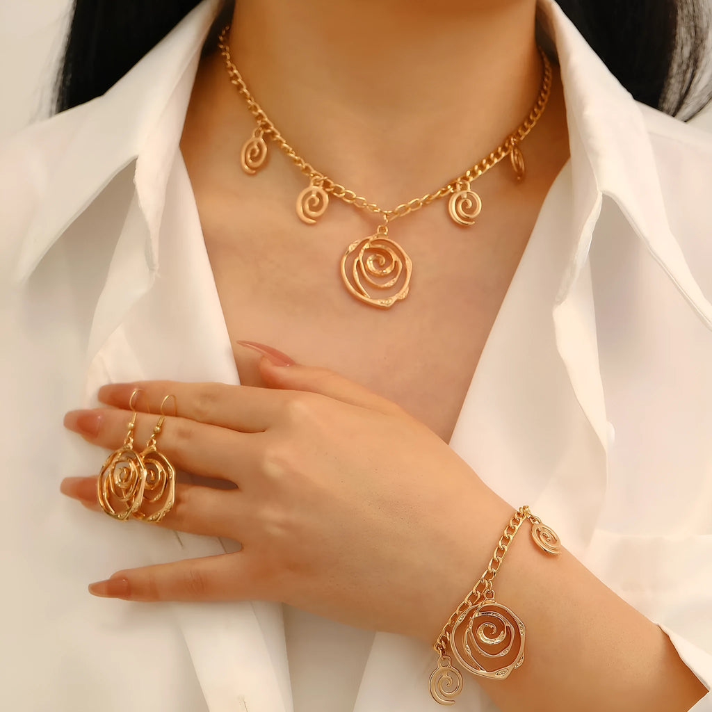Women's spiral donut jewellery set with necklace, bracelet and earrings in gold or silver geometric design