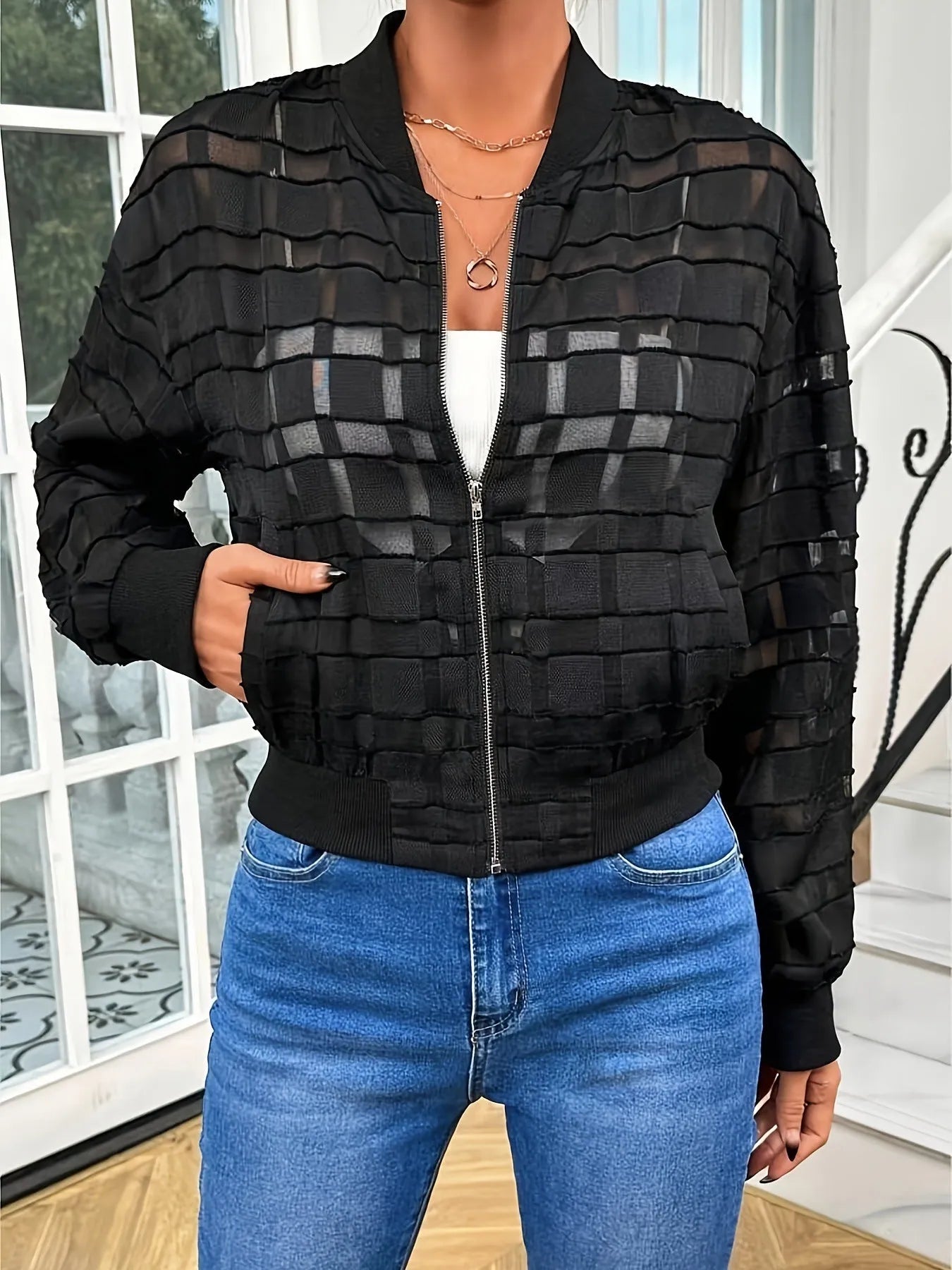 Black women's casual jacket with geometric pattern on semi-transparent fabric and threaded zipper.