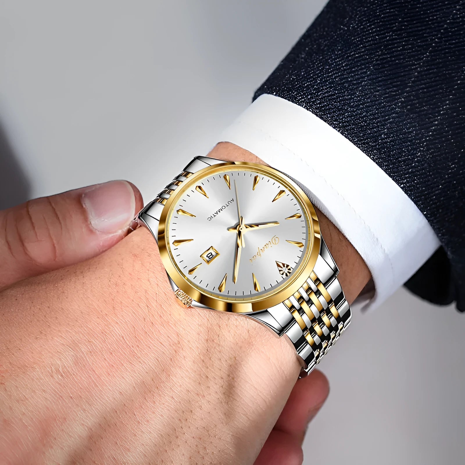Men's simple dial automatic mechanical watch with stainless steel bracelet on a wrist.