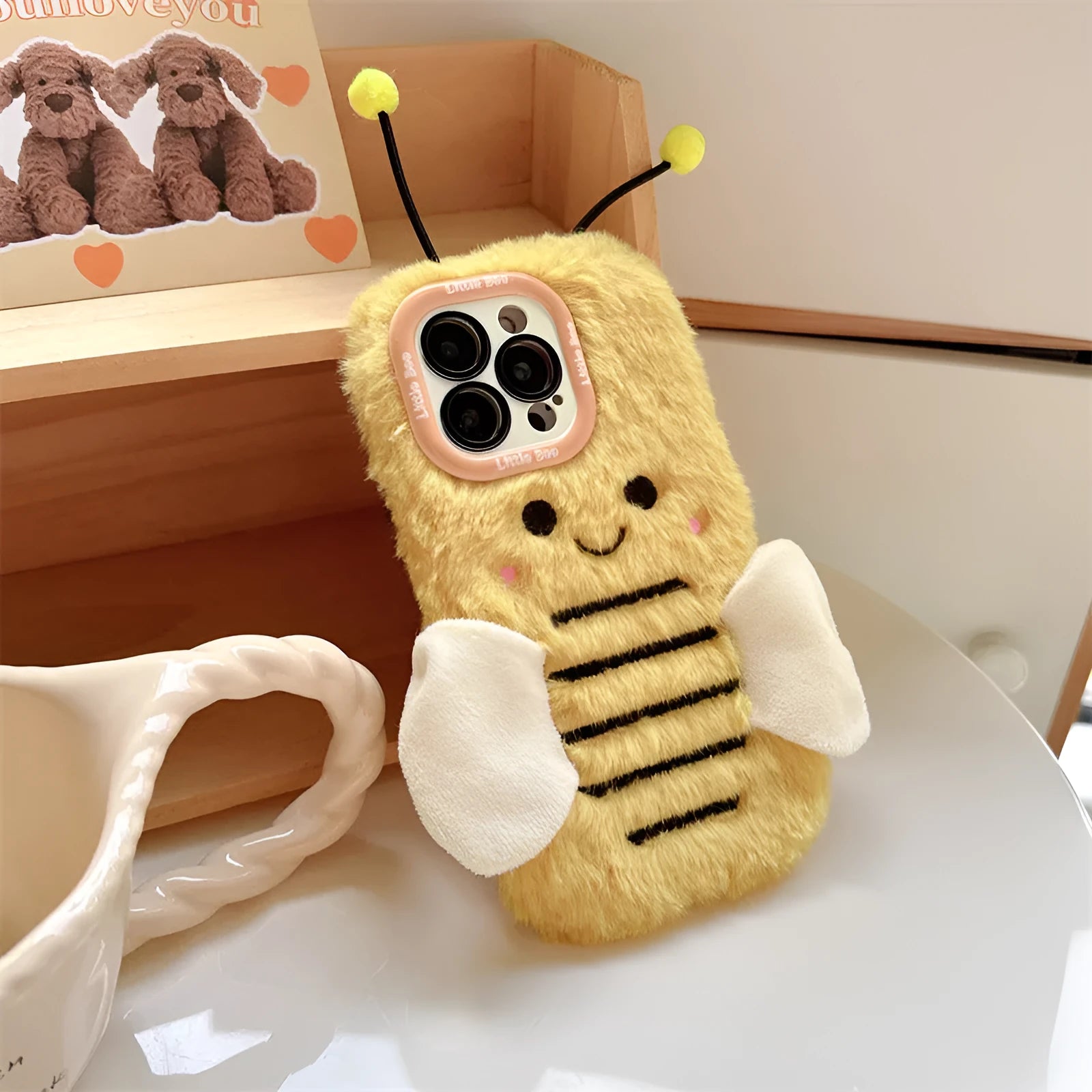 Plush cartoon bee lens bracket phone case in Little Bee colour for iPhone showing furry texture and stand