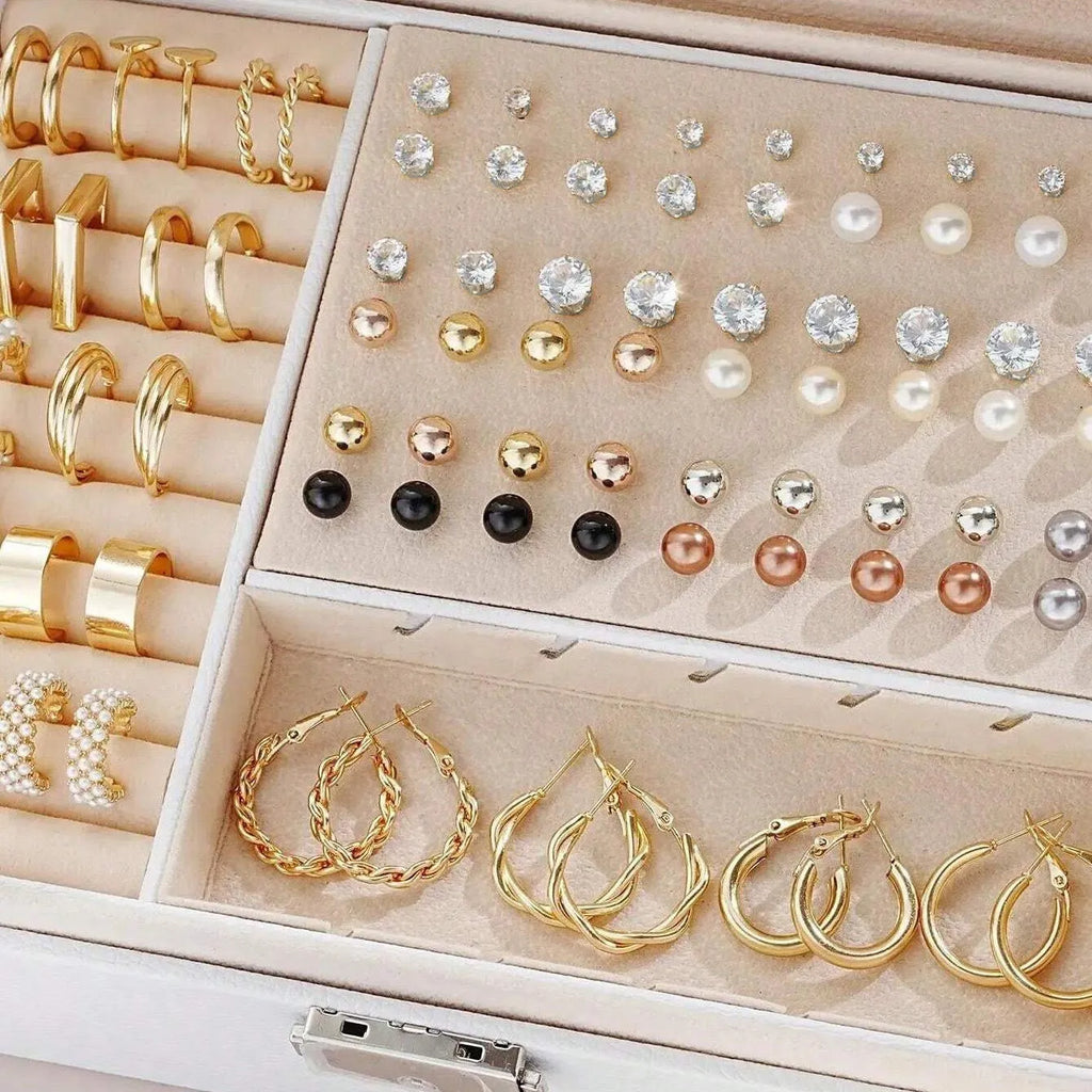 108 gold and yellow geometric and round alloy drop earrings laid out.