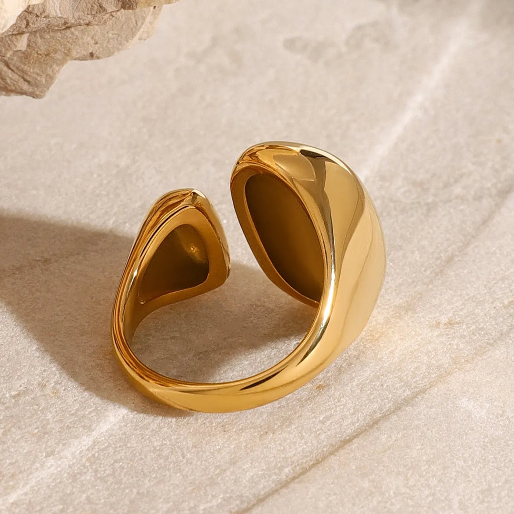 Women's exaggerated geometric open ring in stainless steel with electroplated finish.