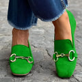 Green suede loafers with round toe, metal fastener, and flat rubber sole