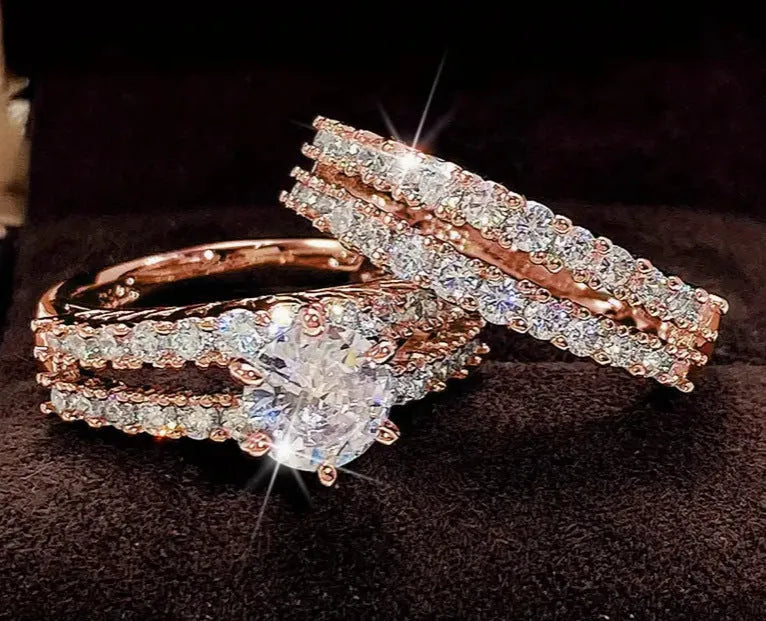 Two-ring women's set showing jewelled and geometric designs in silver, gold, and rose gold alloy