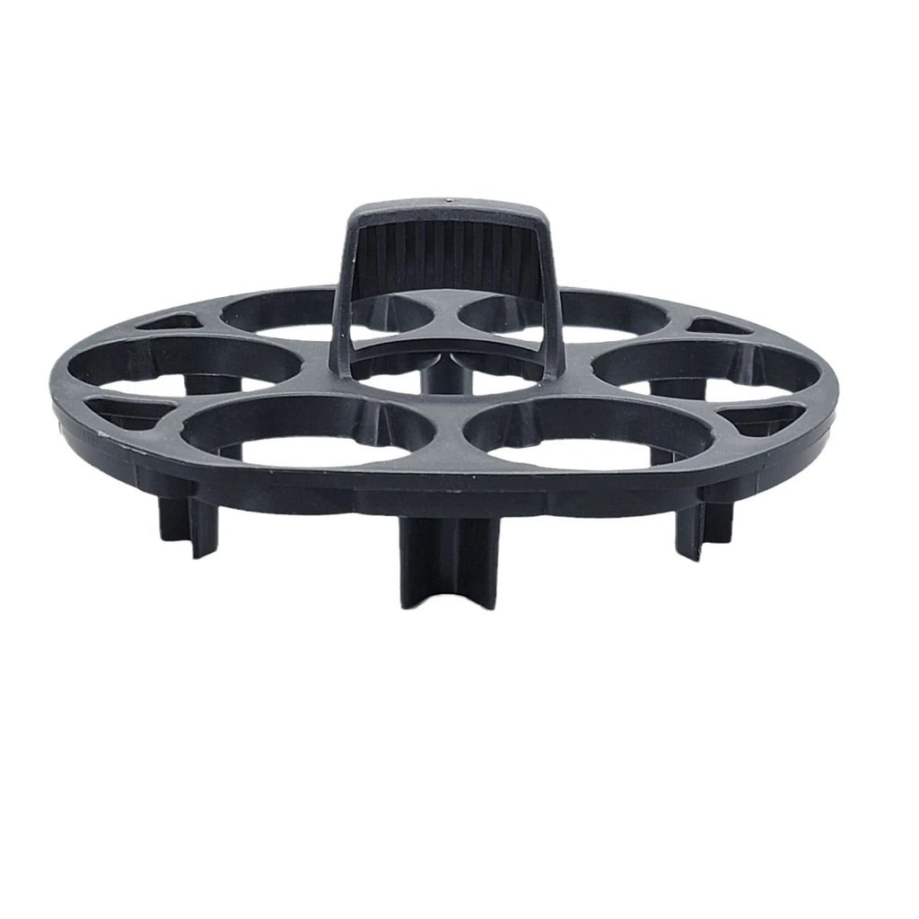 Black plastic egg holder rack for a cooking machine on a kitchen countertop.