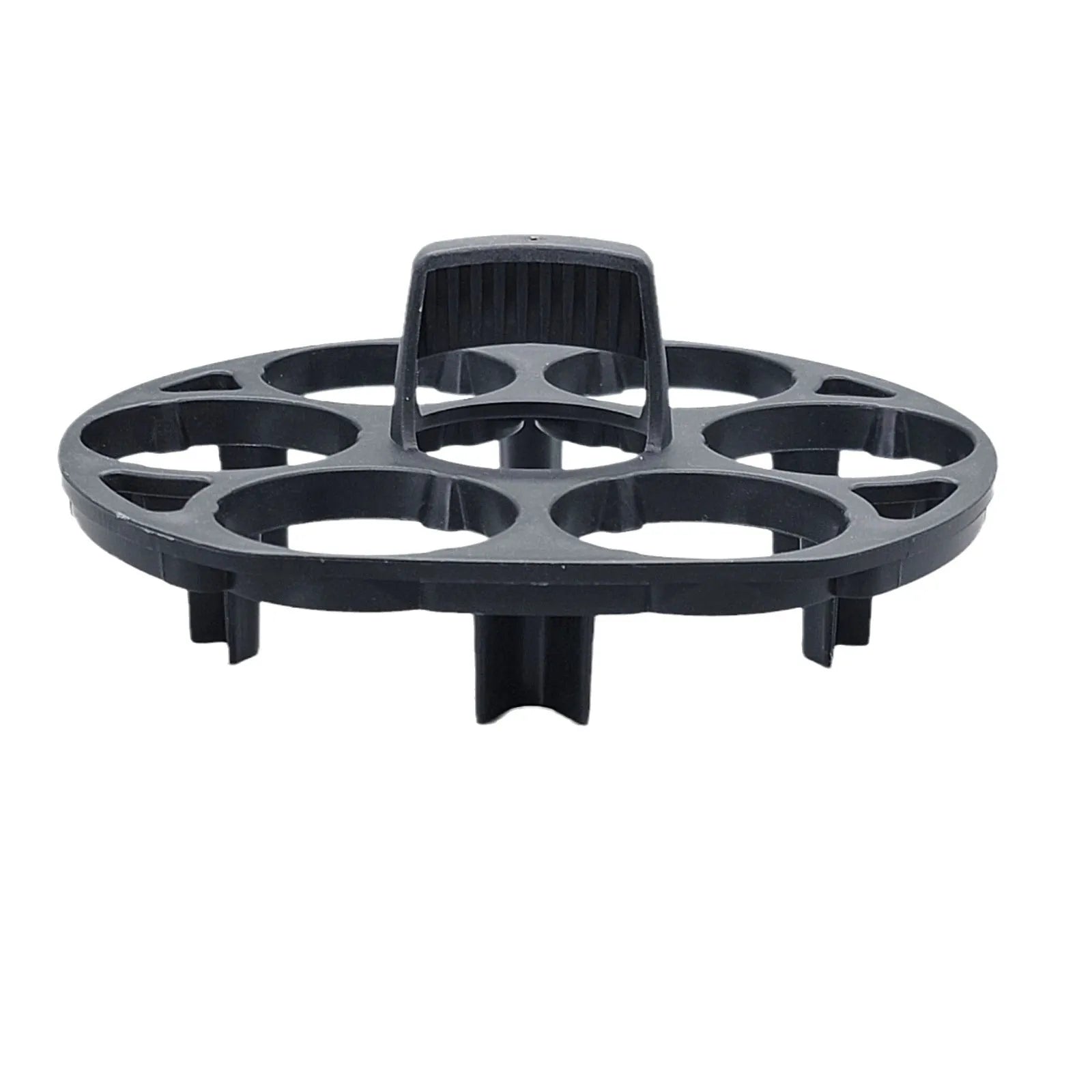 Black plastic egg holder rack for a cooking machine on a kitchen countertop.