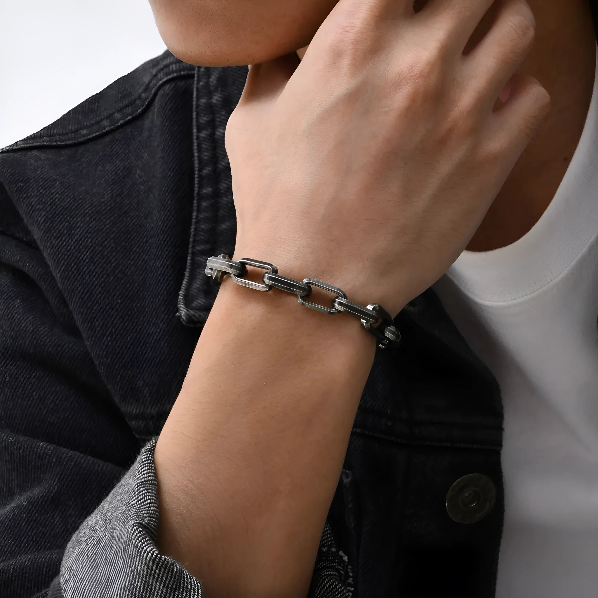 Men's titanium steel square chain bracelet in simple design on wrist.