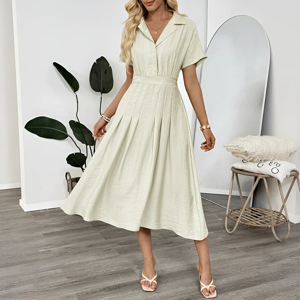 Light green women's lapel collar shirt dress with waist tie and side pockets on a dress form.
