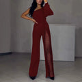 Women's black oblique shoulder jumpsuit with a high leg slit and long sleeves.