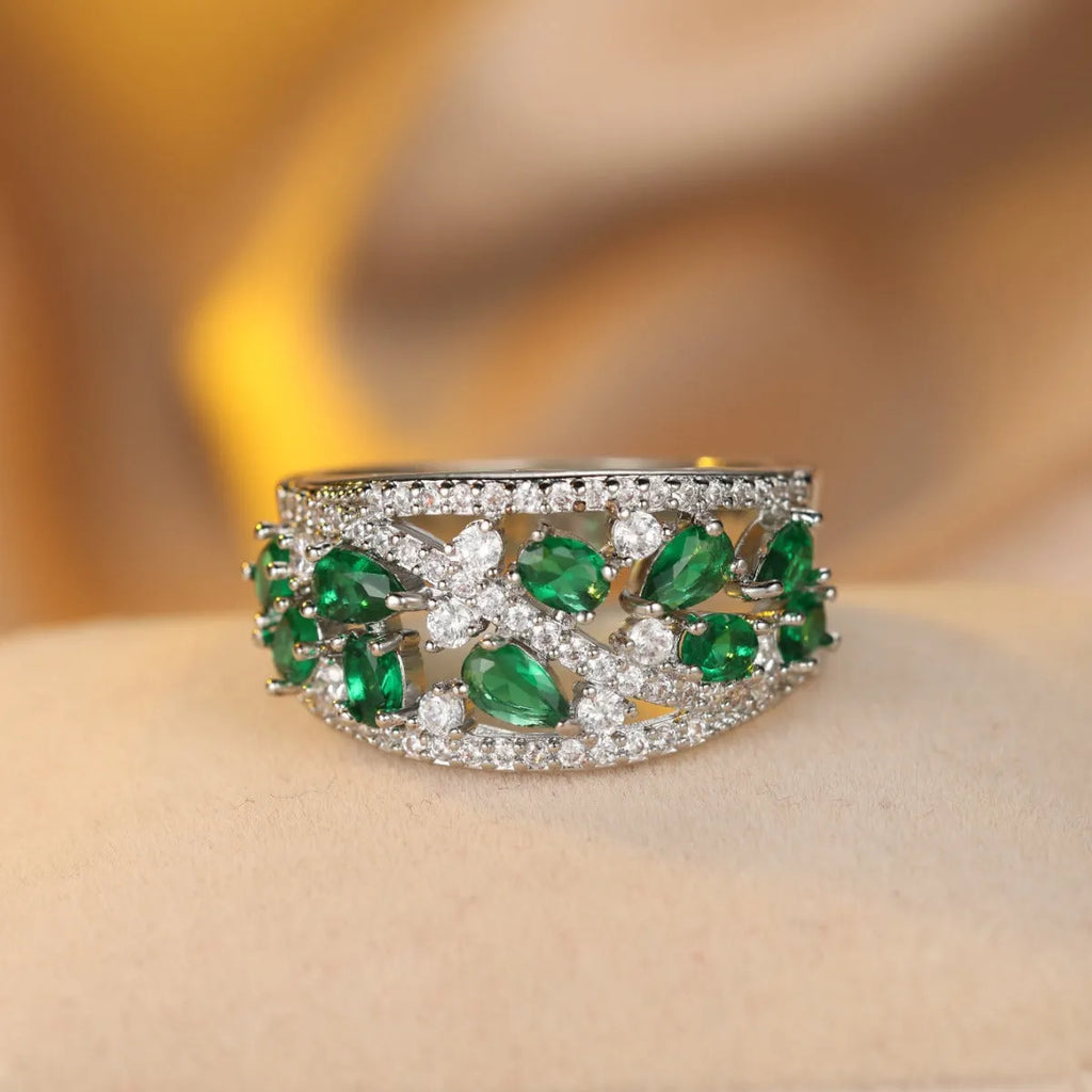 Women's round hollow copper fashion ring with a choice of gemstone colours, shown in gold and platinum finishes.